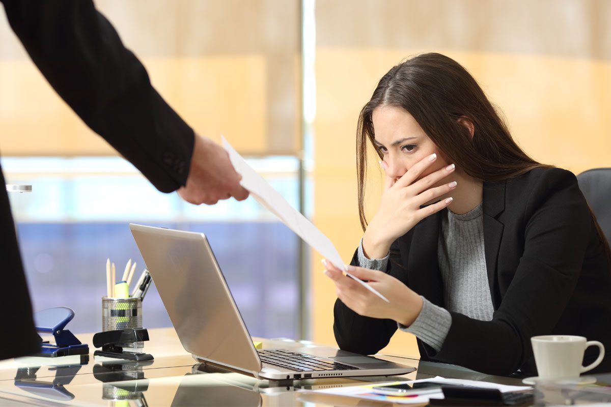 woman receiving notice at work