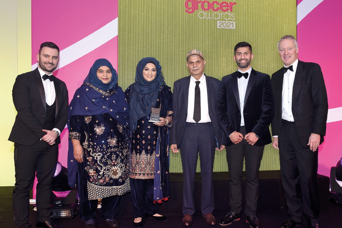 Asiyah, Jawad and family with Rory Bremner accepting Community Retailer of the Year award at Scottish Grocer Awards 2021