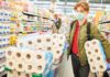 person in supermarket with lots of toilet/kitchen paper