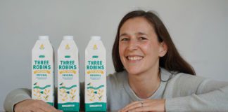 woman holding Three Robins oat milk