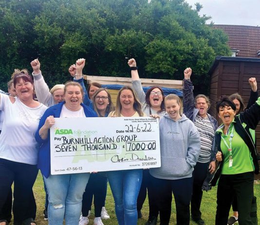 Six figures for charity Burnhill Action Group receiving a giant cheque from the Asda Foundation