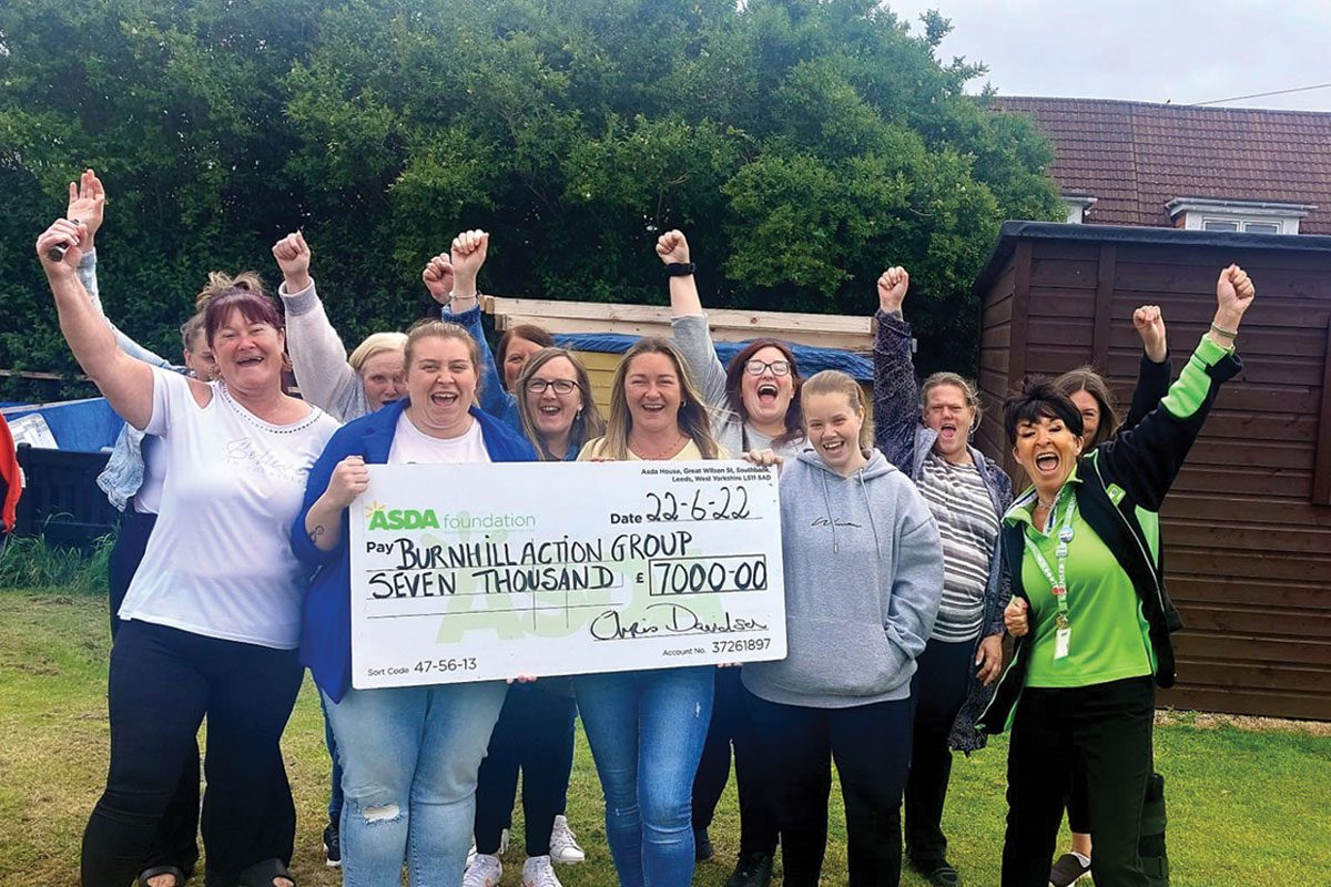 Burnhill Action Group receiving a giant cheque from the Asda Foundation