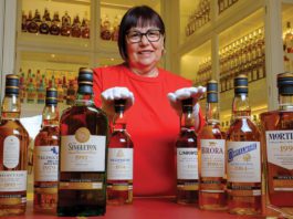 The end of an era Maureen Robinson stands with various whiskey bottles from the diageo brand
