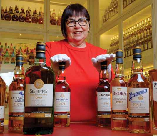 The end of an era Maureen Robinson stands with various whiskey bottles from the diageo brand