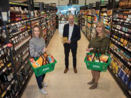 Celebrating quality food and drink Three people stand in a supermarket aisle with baskets of scottish products