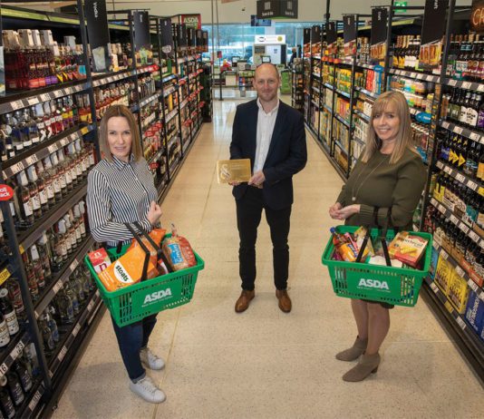 Celebrating quality food and drink Three people stand in a supermarket aisle with baskets of scottish products