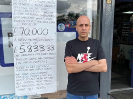 Act on energy or shops will shut Shopkeeper Asif Mohammad stands outside his convenience shop next to a hand written sign about energy prices.