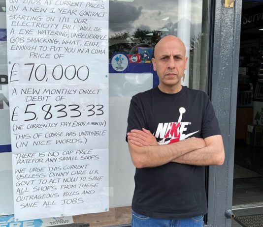 Act on energy or shops will shut Shopkeeper Asif Mohammad stands outside his convenience shop next to a hand written sign about energy prices.