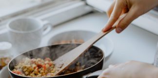 Photograph of someone cooking with a frying pan