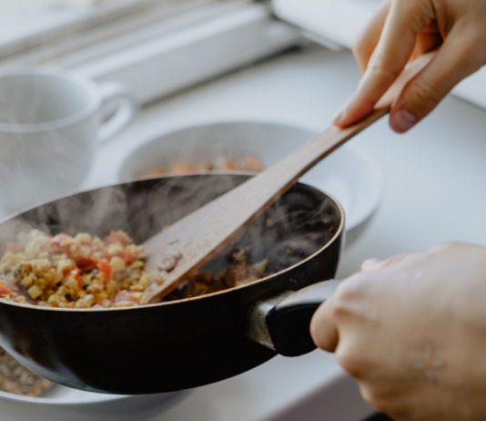 Crisis changes habits Photograph of someone cooking with a frying pan