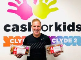 Innovative fundraising George bowie holds packets of mcghees cakes infront of cash for kids sign