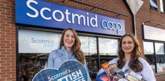 Two woman hold scottish products outside of Scotmid Coop