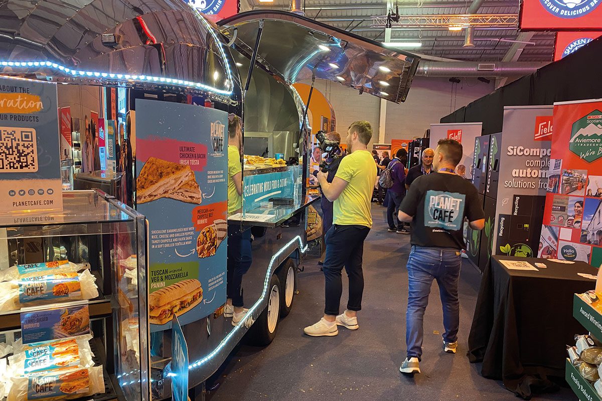 a person ordering from a food van at an indoor conference event