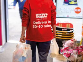 Tech solutions tackling waste a snappy shopper deliver person carries two shopping bags out of a store