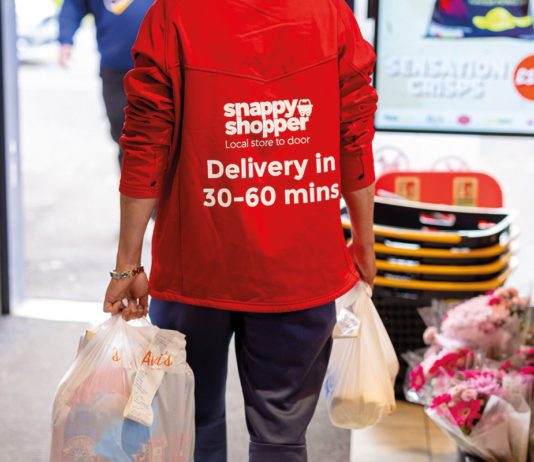 Tech solutions tackling waste a snappy shopper deliver person carries two shopping bags out of a store