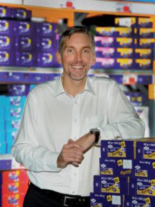 photograph of colin smith standing with a wholesale confectionary goods