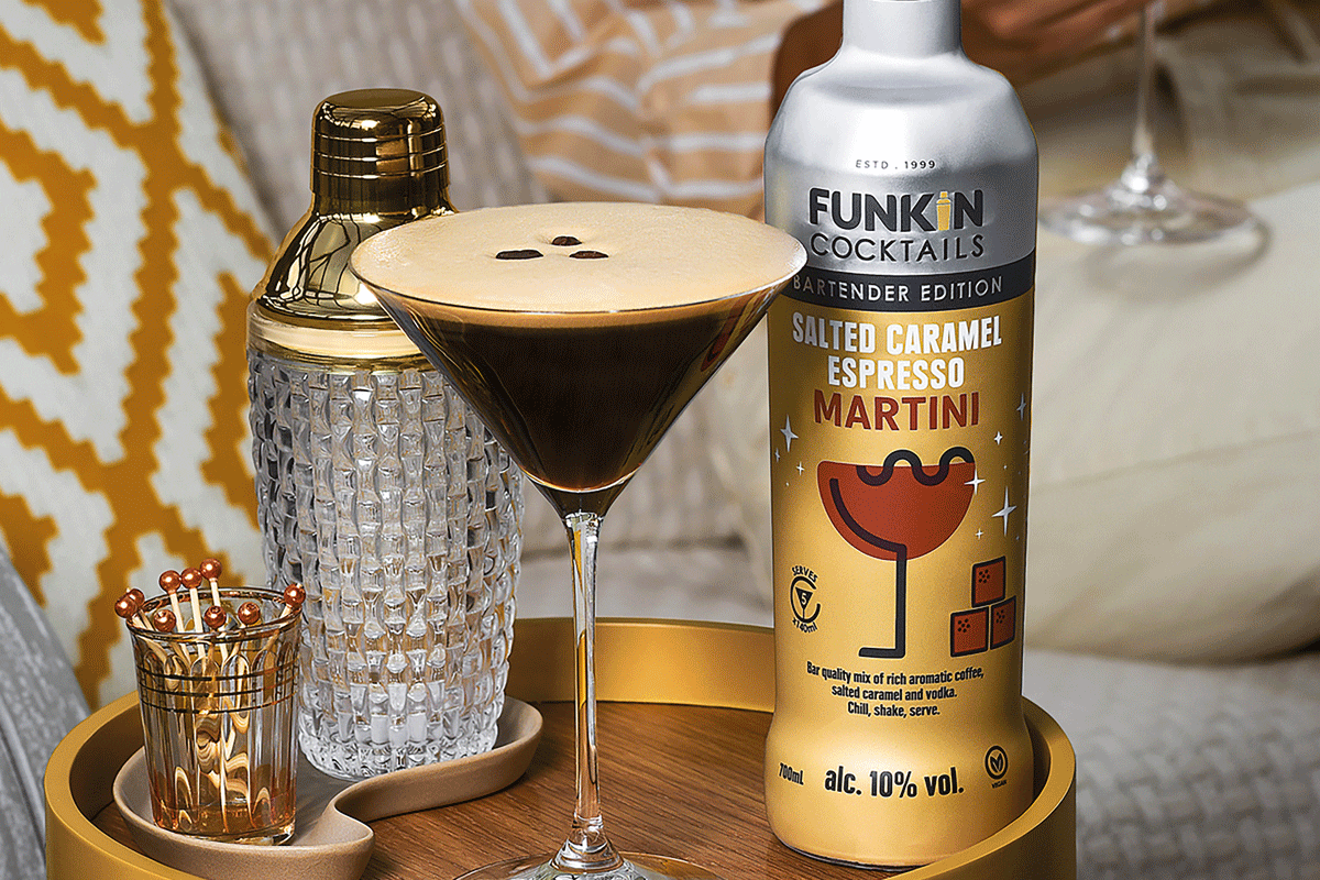 an espresso martini next to a cocktail shaker and bottle of funkin cocktail mix