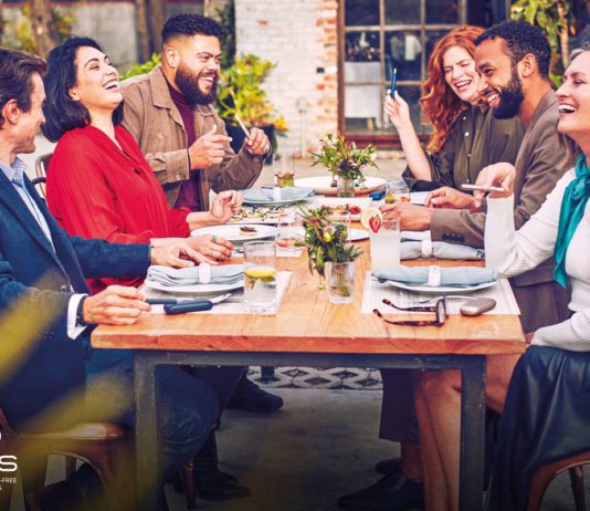 No smoke but plenty of fire for heat-not-burn people sit around a dinner table smoking ecigarettes