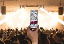 a hand holds a can of whiteclaw in a club