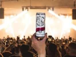 White Claw brings Hard Seltzer into the hands of clubbers a hand holds a can of whiteclaw in a club