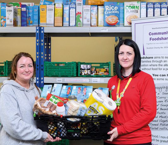 Donations hit milestone at Asda stores Two women hold a basket of food