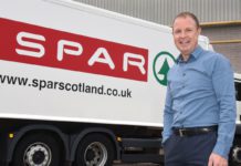 Colin MacLean stands infront of a Spar delivery truck.