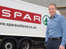 CJ Lang boosts profits Colin MacLean stands infront of a Spar delivery truck.