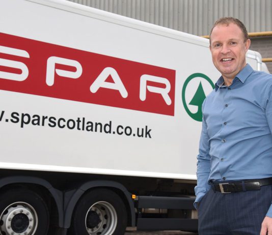 CJ Lang boosts profits Colin MacLean stands infront of a Spar delivery truck.