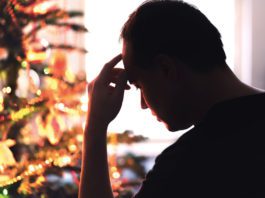 A grim Golden Quarter a man looks pensive infront of a christmas tree