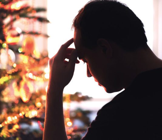A grim Golden Quarter a man looks pensive infront of a christmas tree