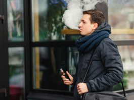 Online help to inform retailers a man vapes outdoors