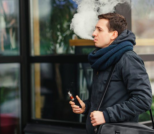 Online help to inform retailers a man vapes outdoors