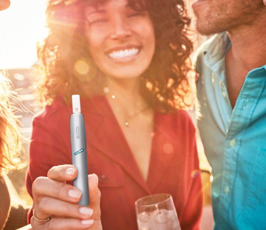 Phillip Morris Limited launch revamped IQOS smoke free devices a smiling woman holds an e-cigarette