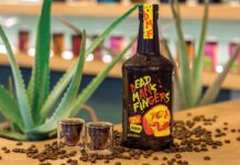 a bottle of dead mans fingers coffee liqueur with two shot glasses