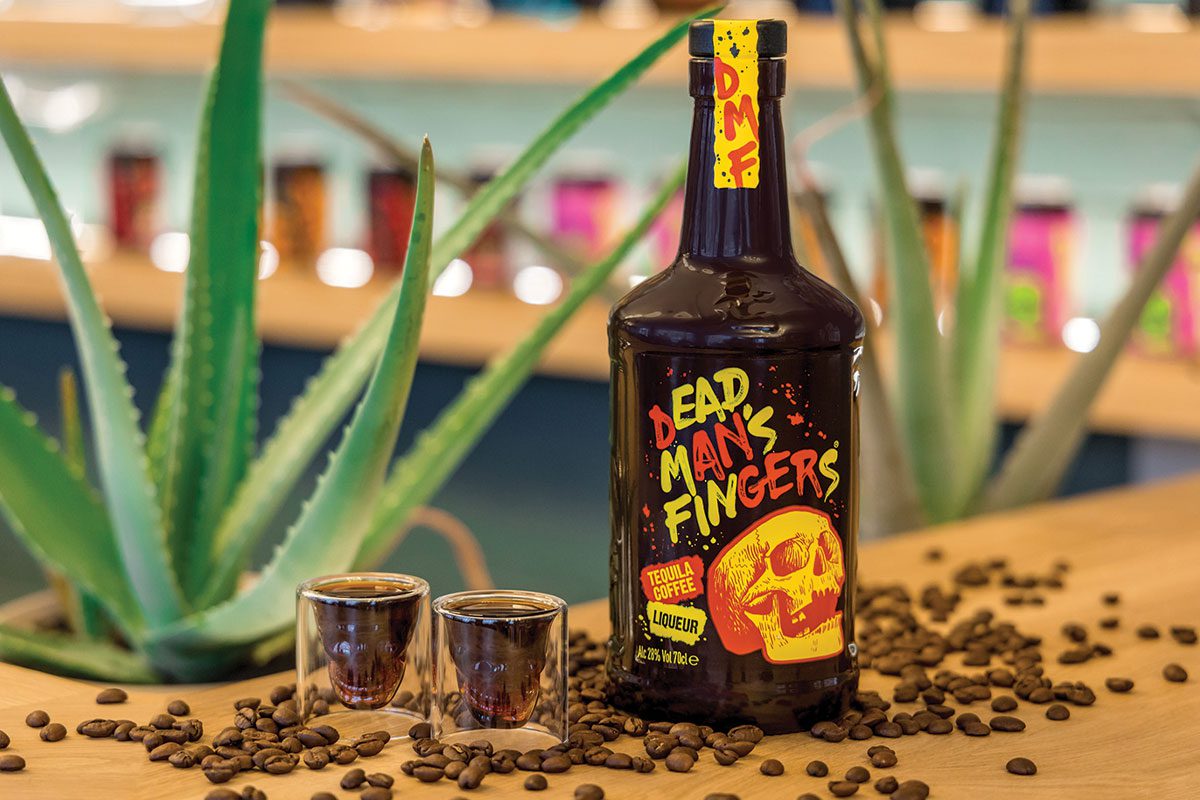 a bottle of dead mans fingers coffee liqueur with two shot glasses