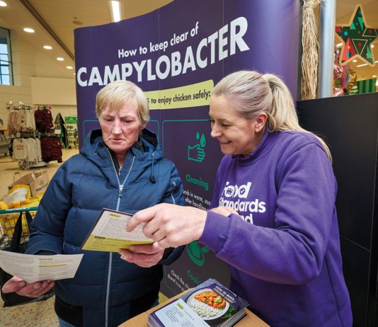 Boosting food safety with Food Standards Scotland a food standards Scotland employee hands a leaflet to a customer
