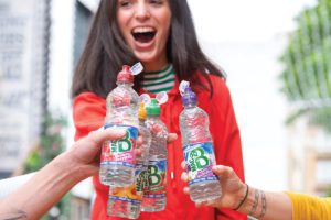 People cheers with different flavours of MacB bottled water