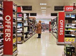 Black Friday sales brought relief over the festivities a woman stands in a supermarket aisle