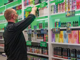 Vaping sector boosts economy according to study a person stocks the shelves of a vape store