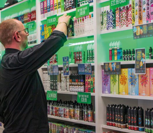 Vaping sector boosts economy according to study a person stocks the shelves of a vape store