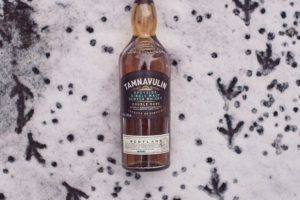 a bottle of tamnavulin malt whisky in the snow