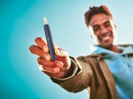 Heat-not-burn to fire up sales man holding vape