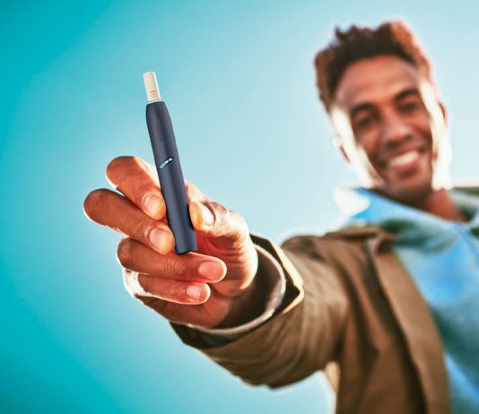 Heat-not-burn to fire up sales man holding vape