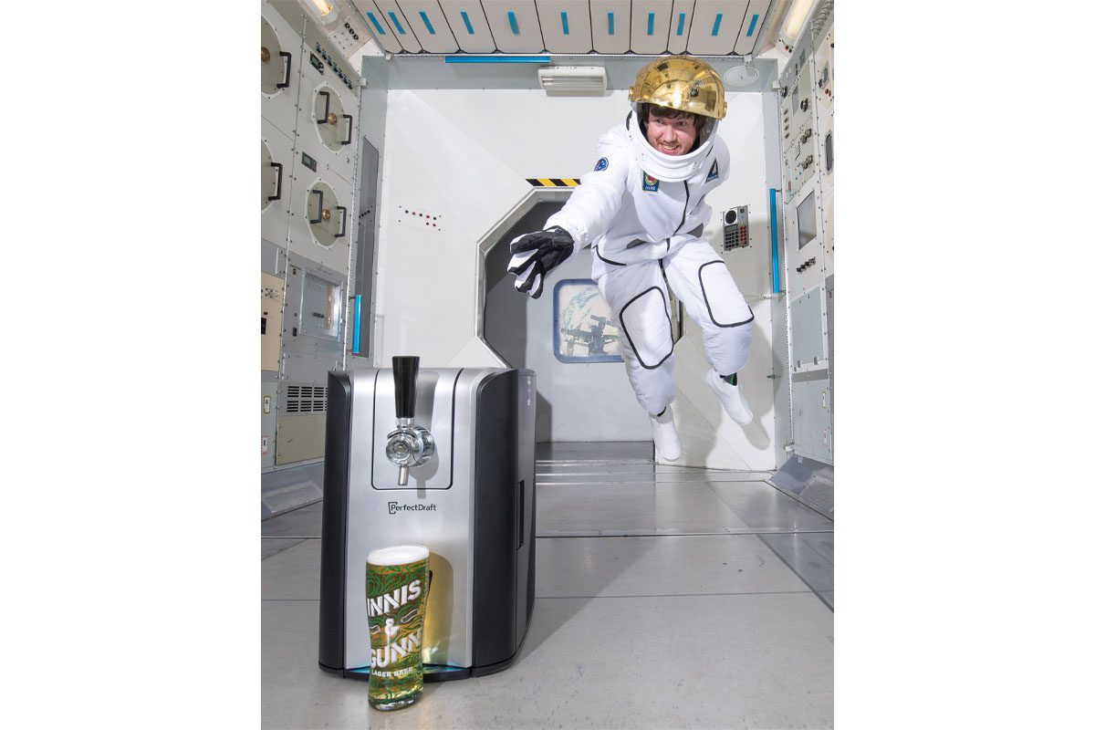 astronaut reaching for a pint of beer