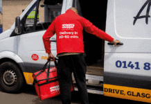 A Snappy shopper delivery driver loads a white van