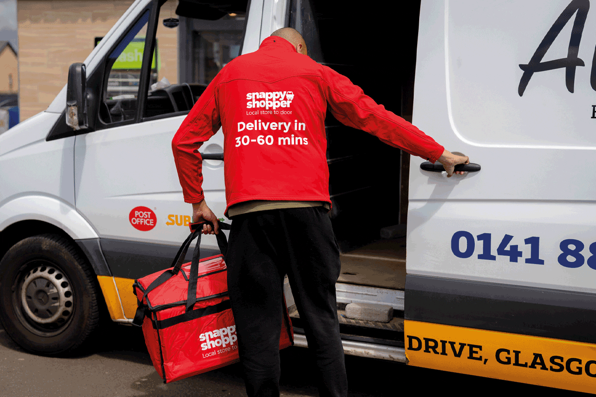 A Snappy shopper delivery driver loads a white van 