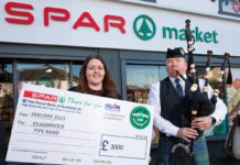 SPAR colleague with cheque and bag piper