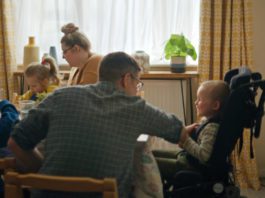 McCain’s charity donation supports Family Fund A family sit around eating chips at a dinner table