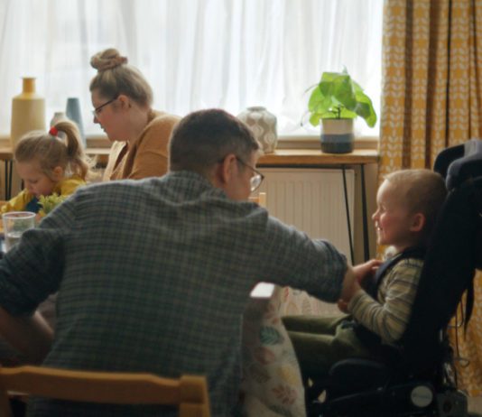 McCain’s charity donation supports Family Fund A family sit around eating chips at a dinner table