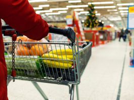A positive December performance for Scottish retail A shopper pushes a trolley or groceries in a store.